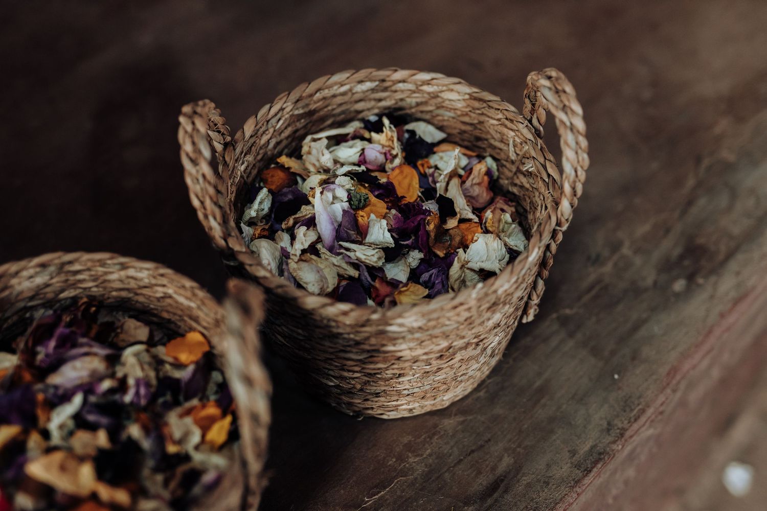 Woven basket filled with colorful dried flower petals and confetti.