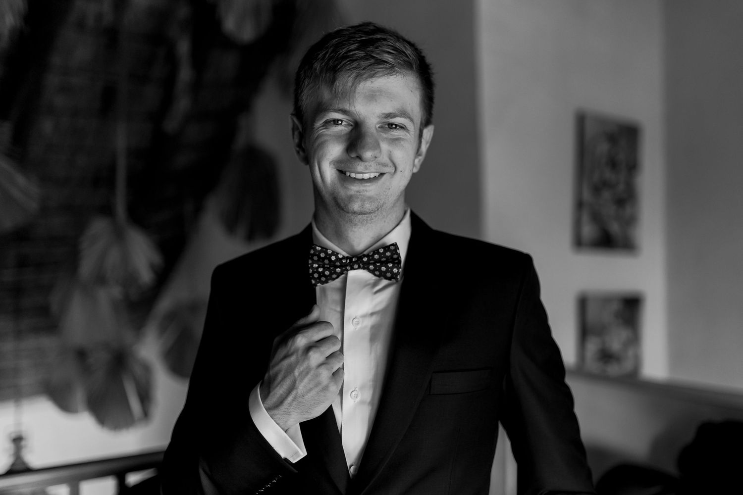 Black and white formal portrait showing classic tuxedo styling.