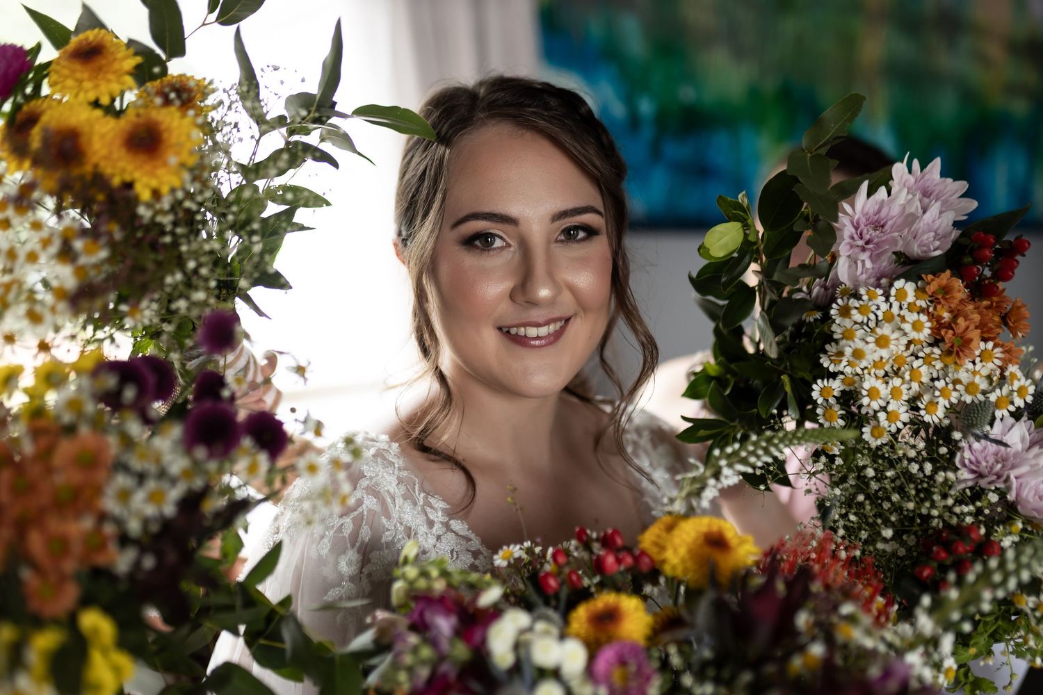 A joyful bridal portrait framed by colorful summer flowers and natural light.
