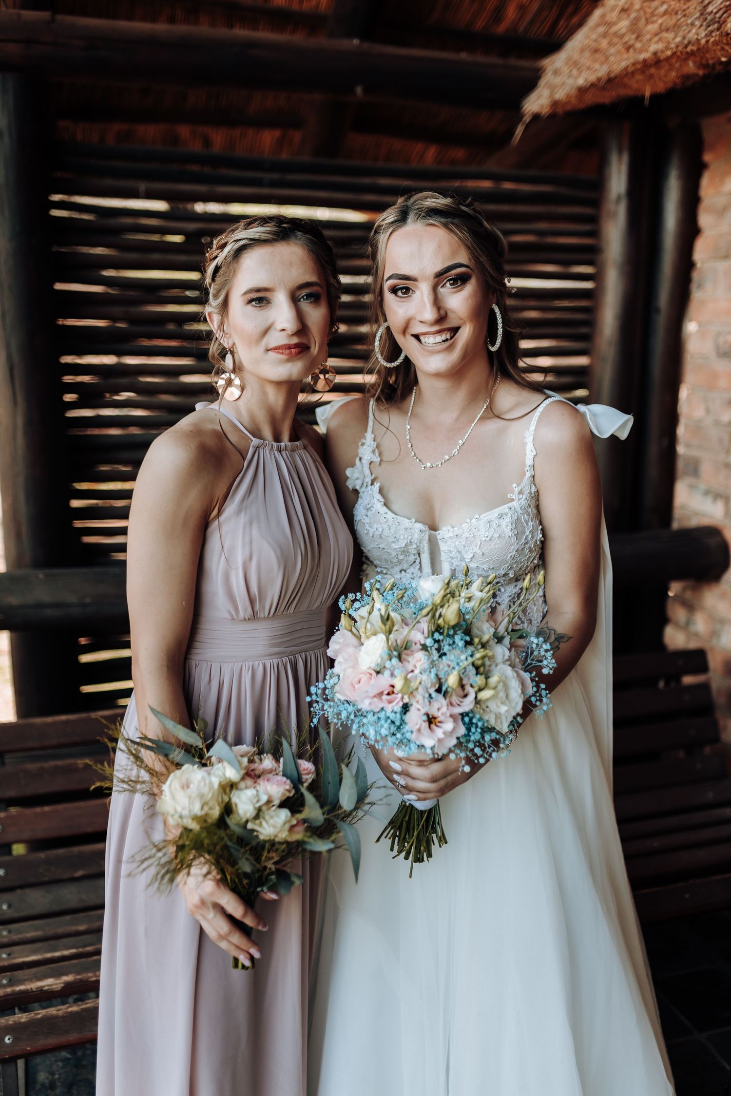 Elegant bridal party portrait with dusty rose bridesmaid dress and white wedding gown.
