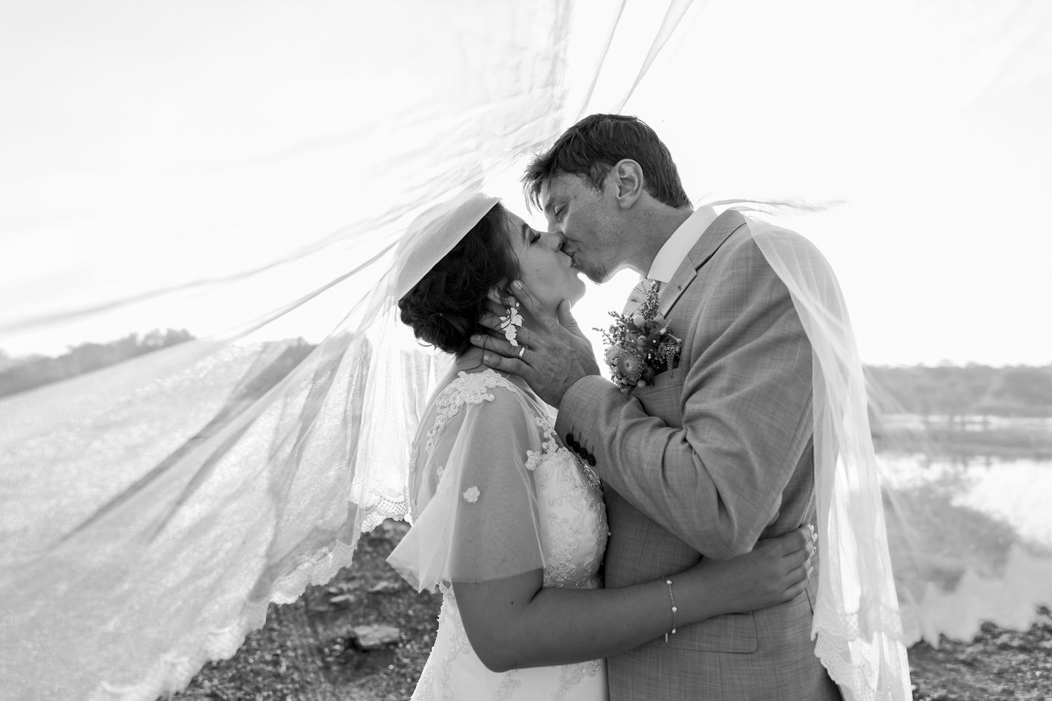 A black and white photo captures a tender moment between a couple.