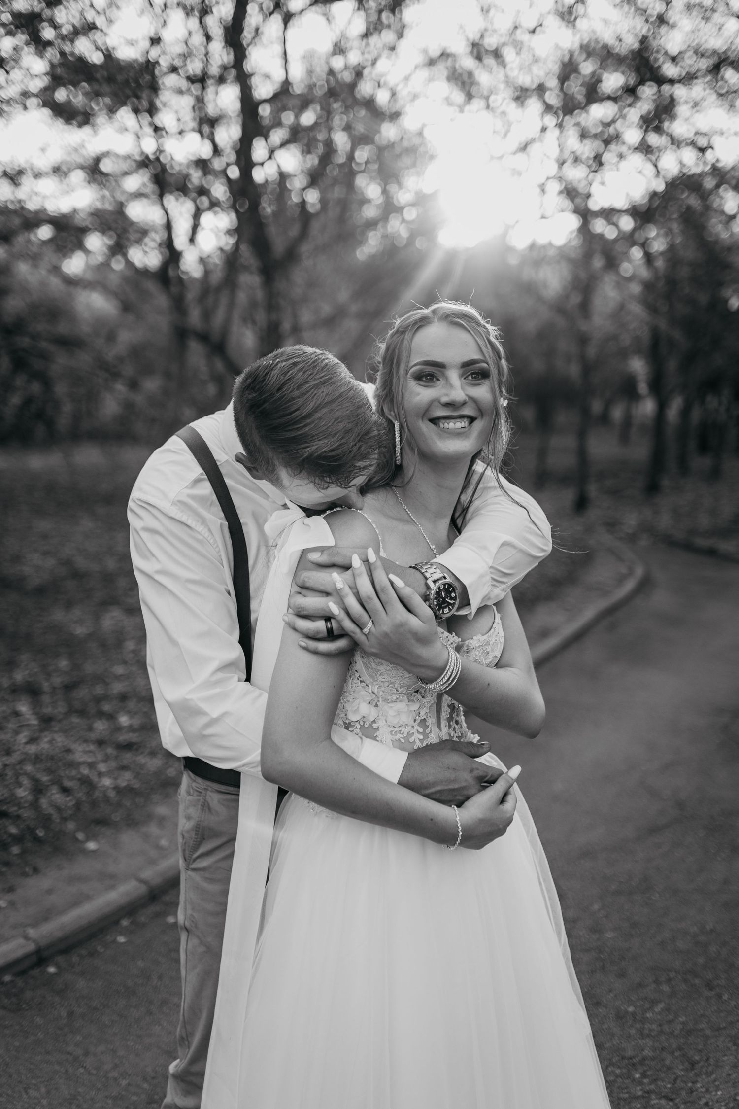 Black and white portrait of a loving couple sharing a wedding day moment.