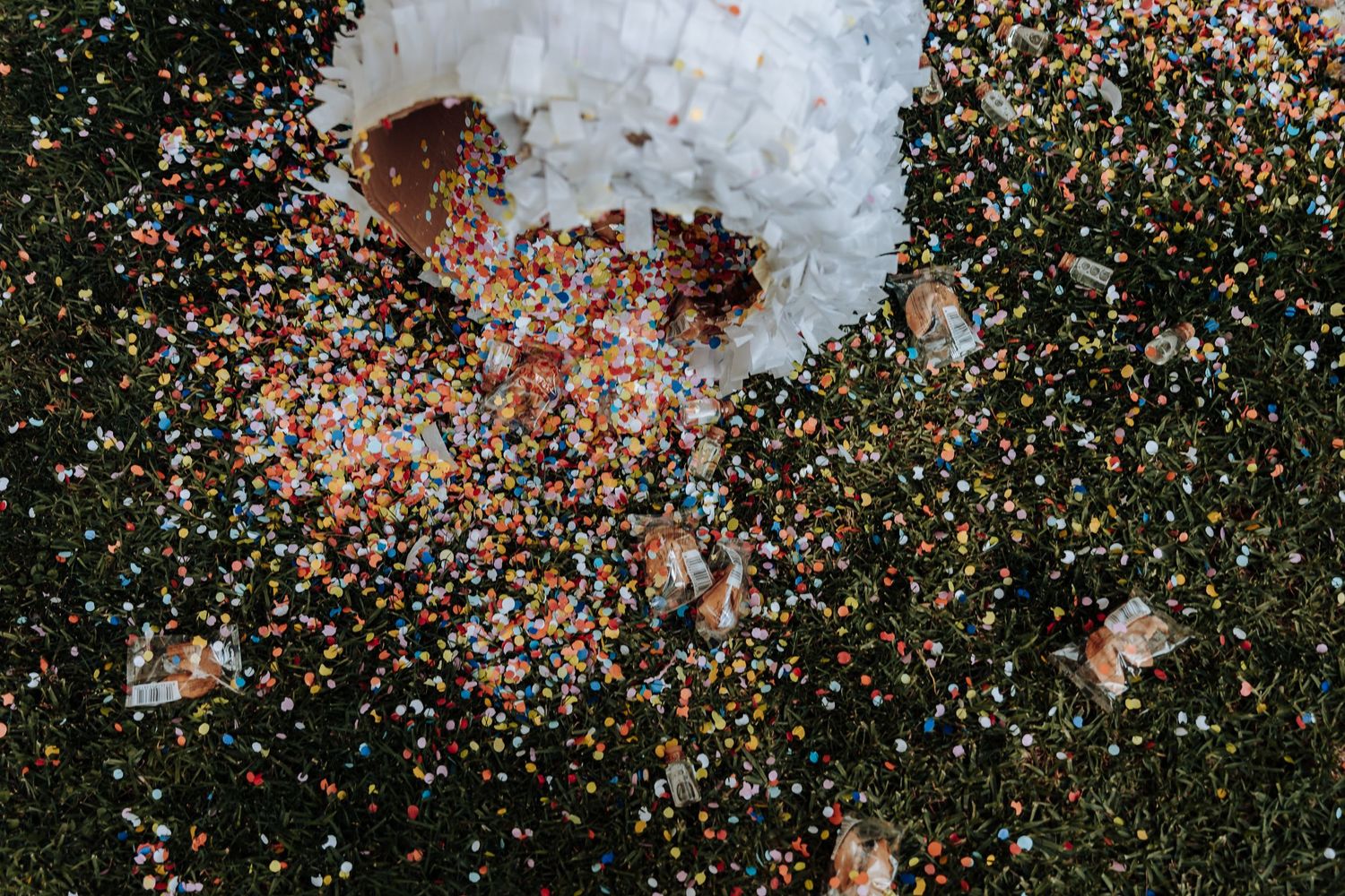 Colorful confetti exploding in a dynamic motion blur against a dark background.