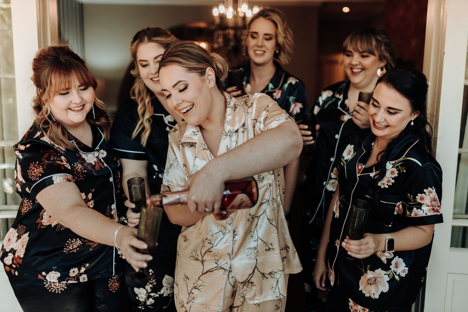 A candid moment of celebration with matching floral robes.