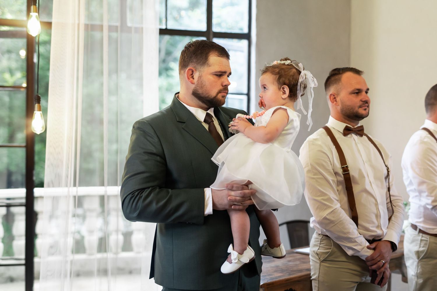 Tender moment captured during wedding ceremony in elegant venue with natural lighting.