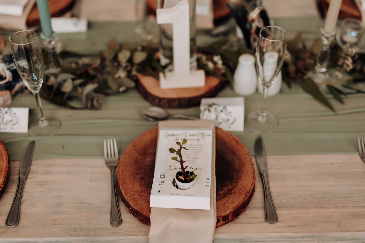 Rustic table setting with terracotta plates, white napkins and custom place cards.