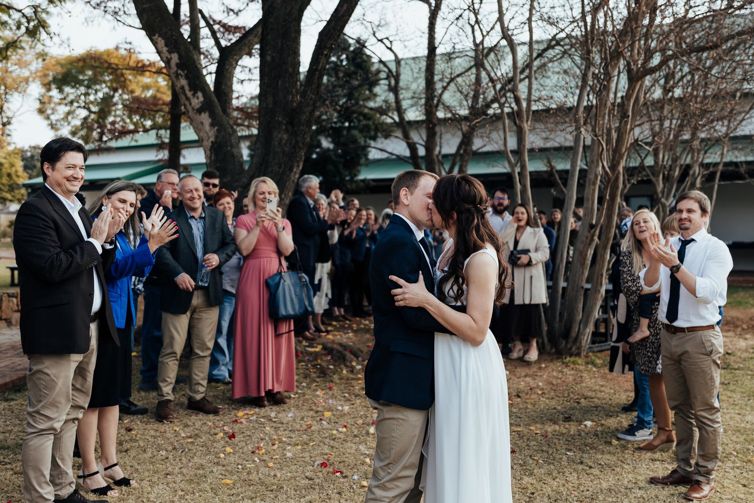 Wedding guests celebrate outdoors during a joyful afternoon celebration.