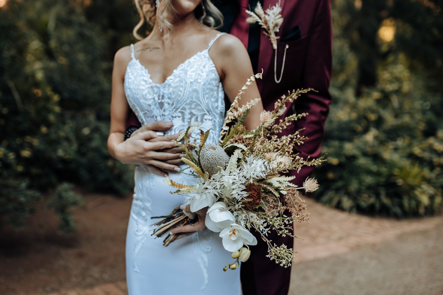 Close up of a dried flower wedding bouquet with white and neutral tones.