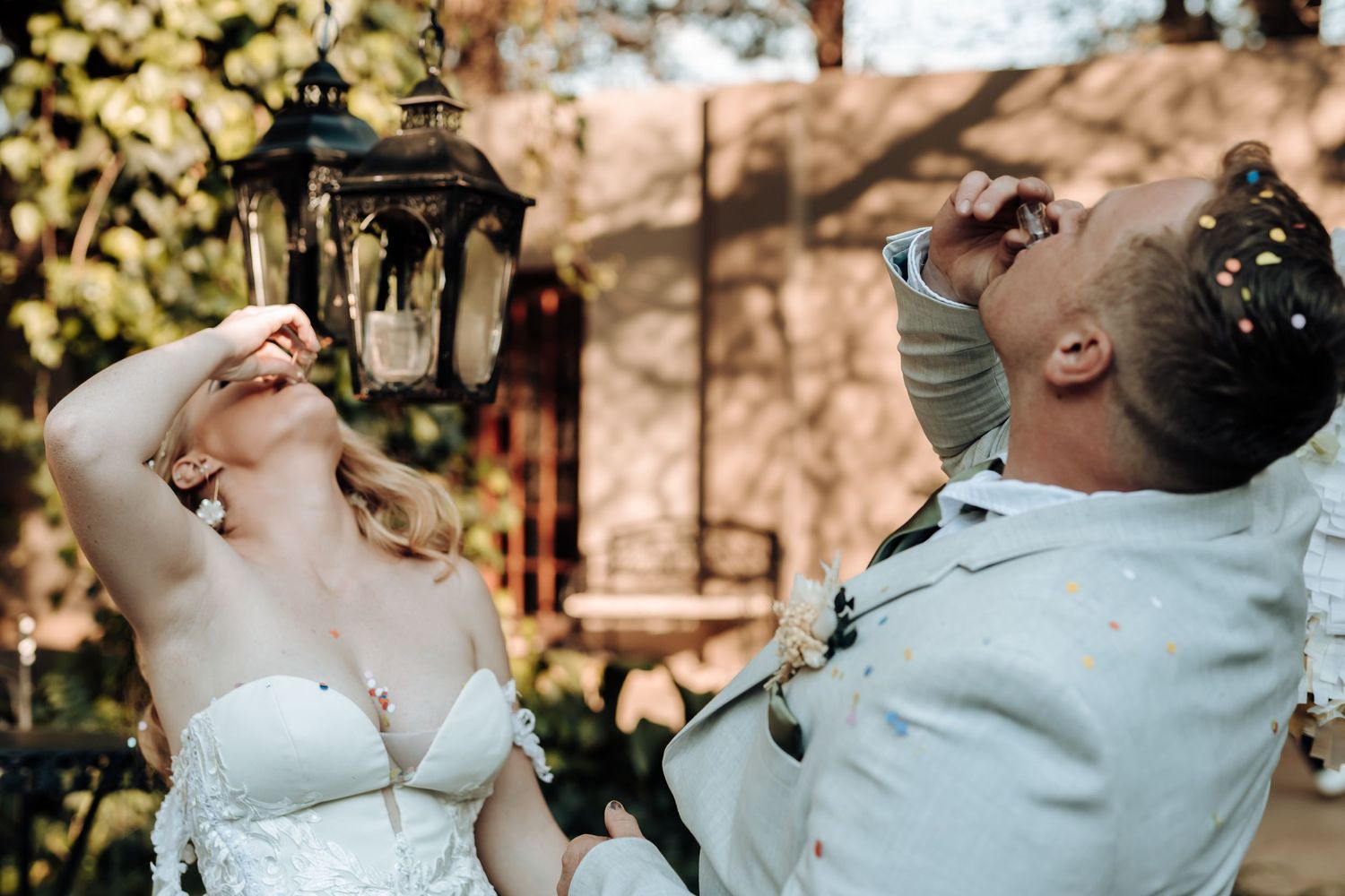 Joyful couple laughing and celebrating during their wedding ceremony.