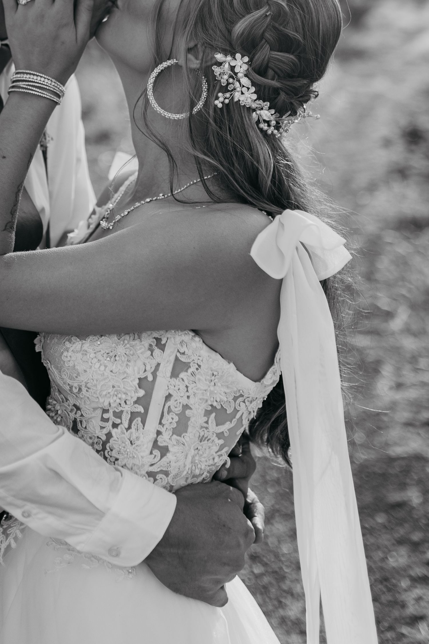 Close-up detail of bridal hair accessory and lace dress back.