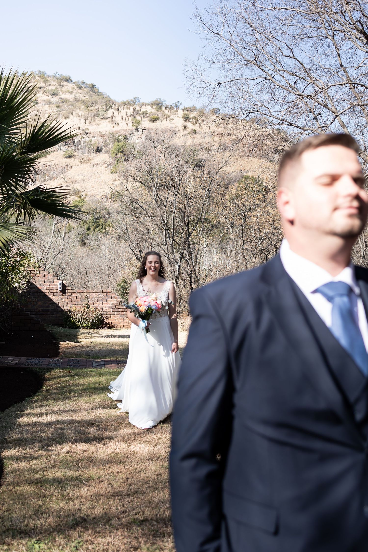 A sequence of candid wedding photos showing a couple in white dress and navy suit posing playfully outdoors in nature.