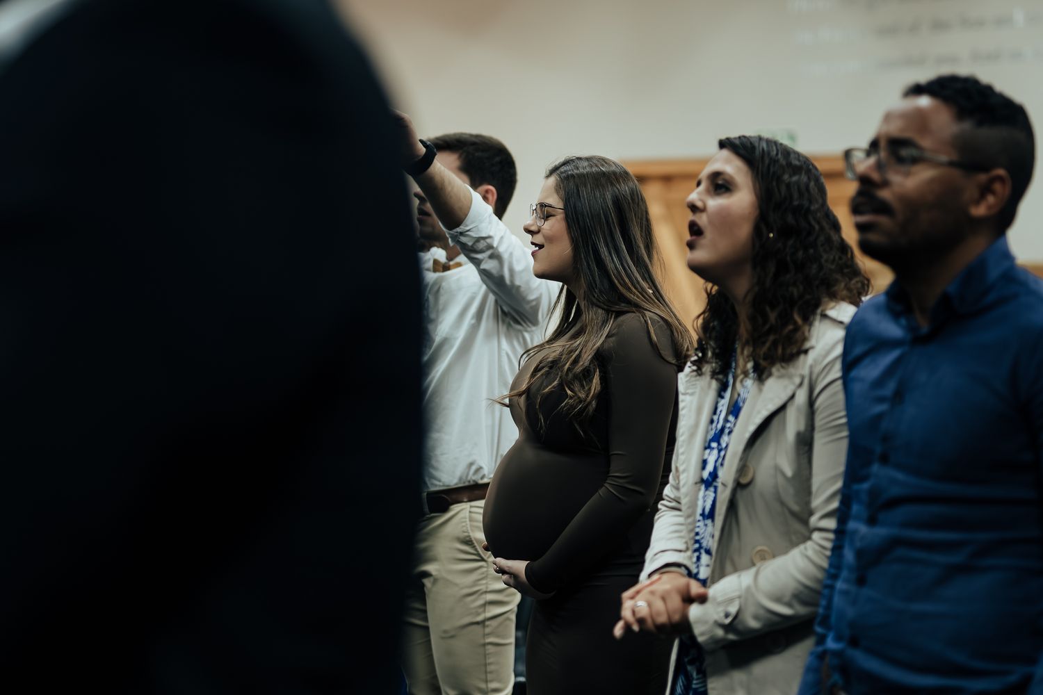 A group of people singing together during a church service or worship gathering.