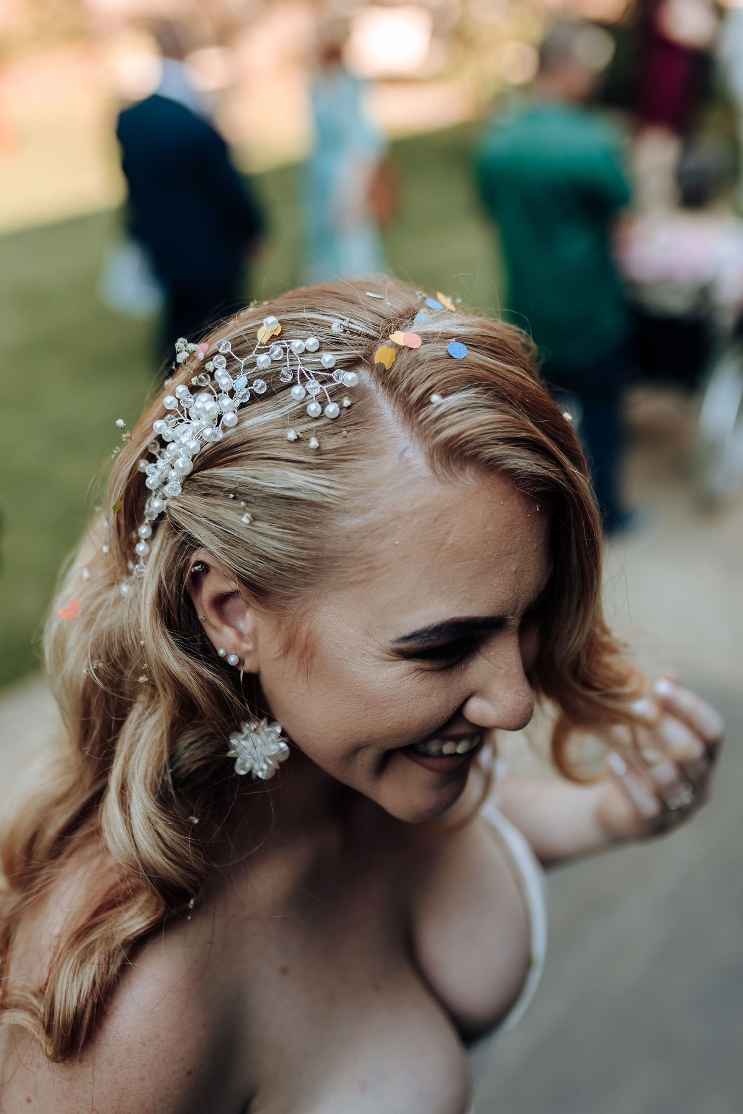Elegant bridal hairstyle with crystal hairpiece and soft waves.