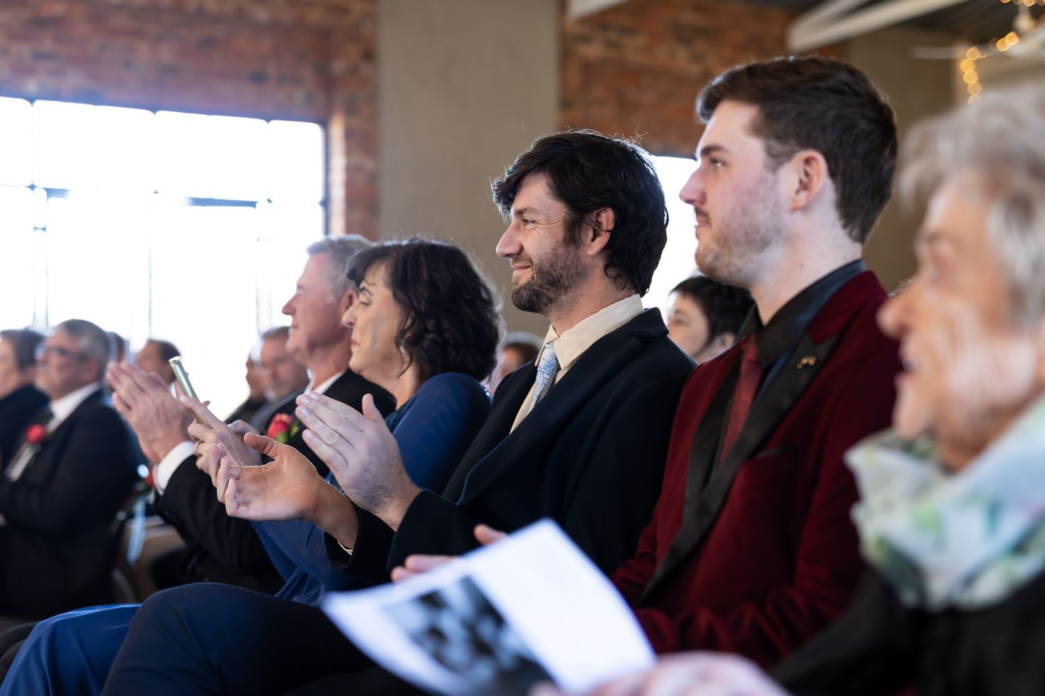 A group of business professionals engage in animated conversation during a crowded networking event.
