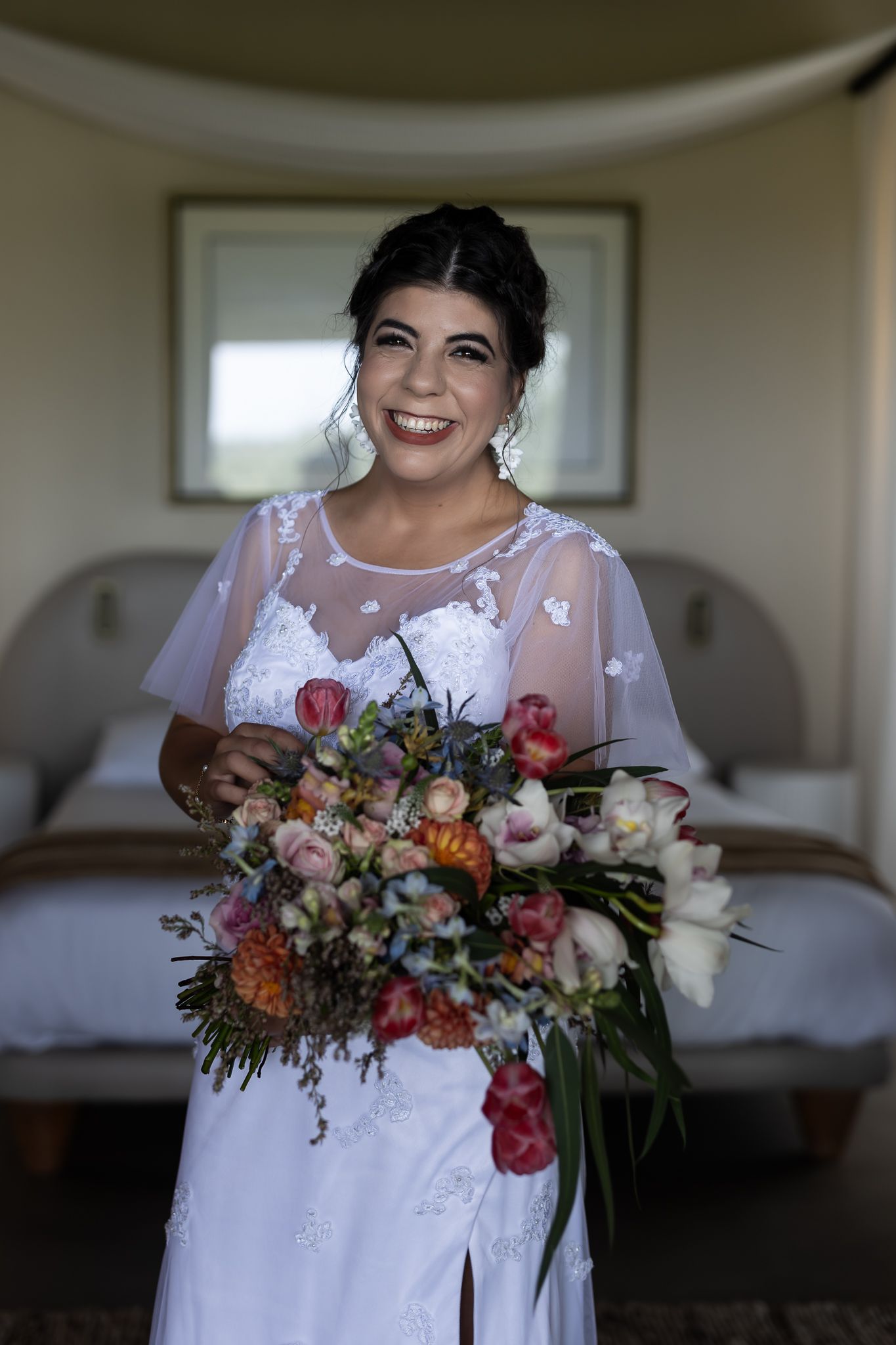 A joyful moment captured with a wedding bouquet and elegant white dress.