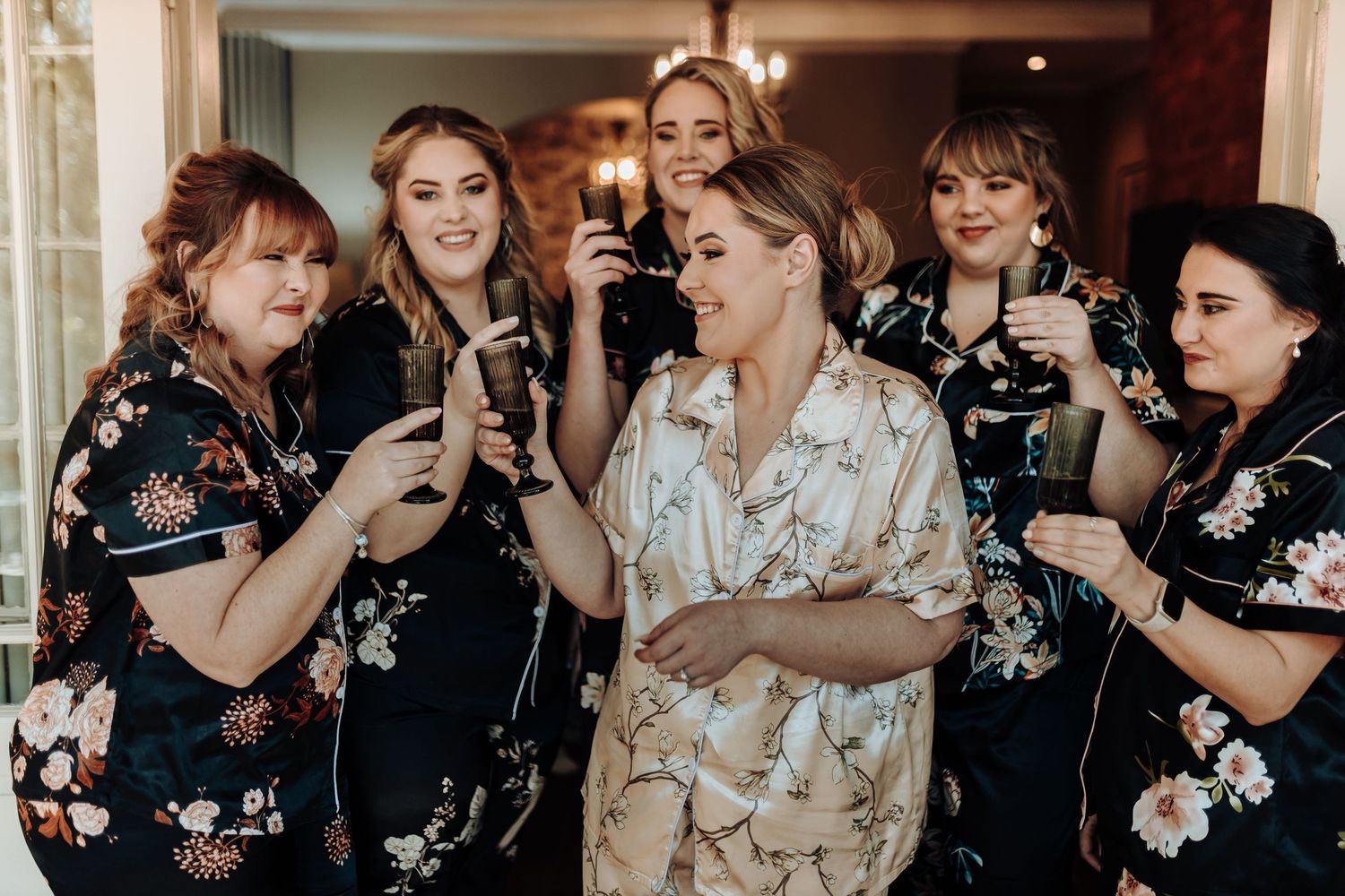 A celebration gathering with drinks and matching floral pattern robes.