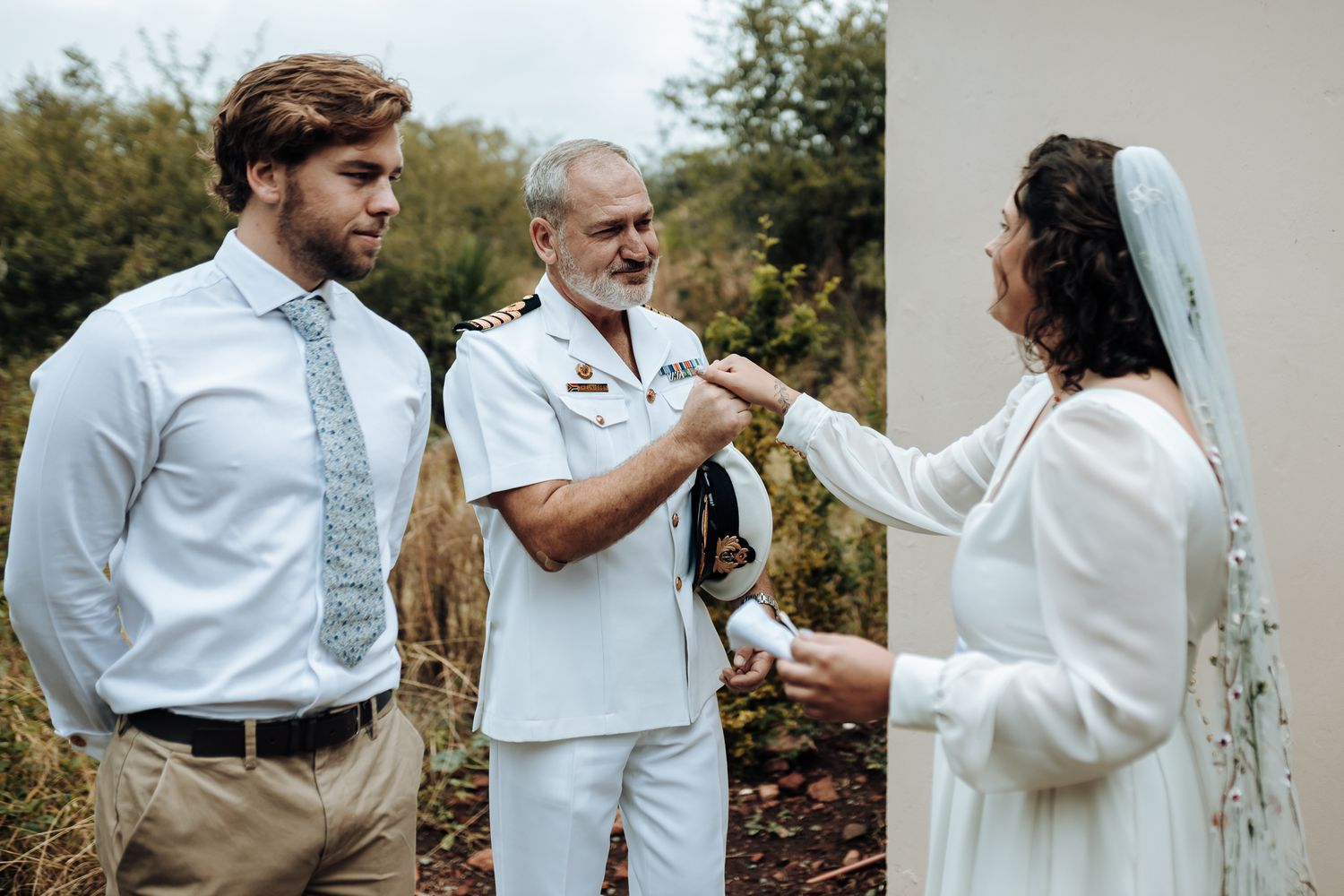 Wedding ceremony participants sharing an emotional moment outdoors.