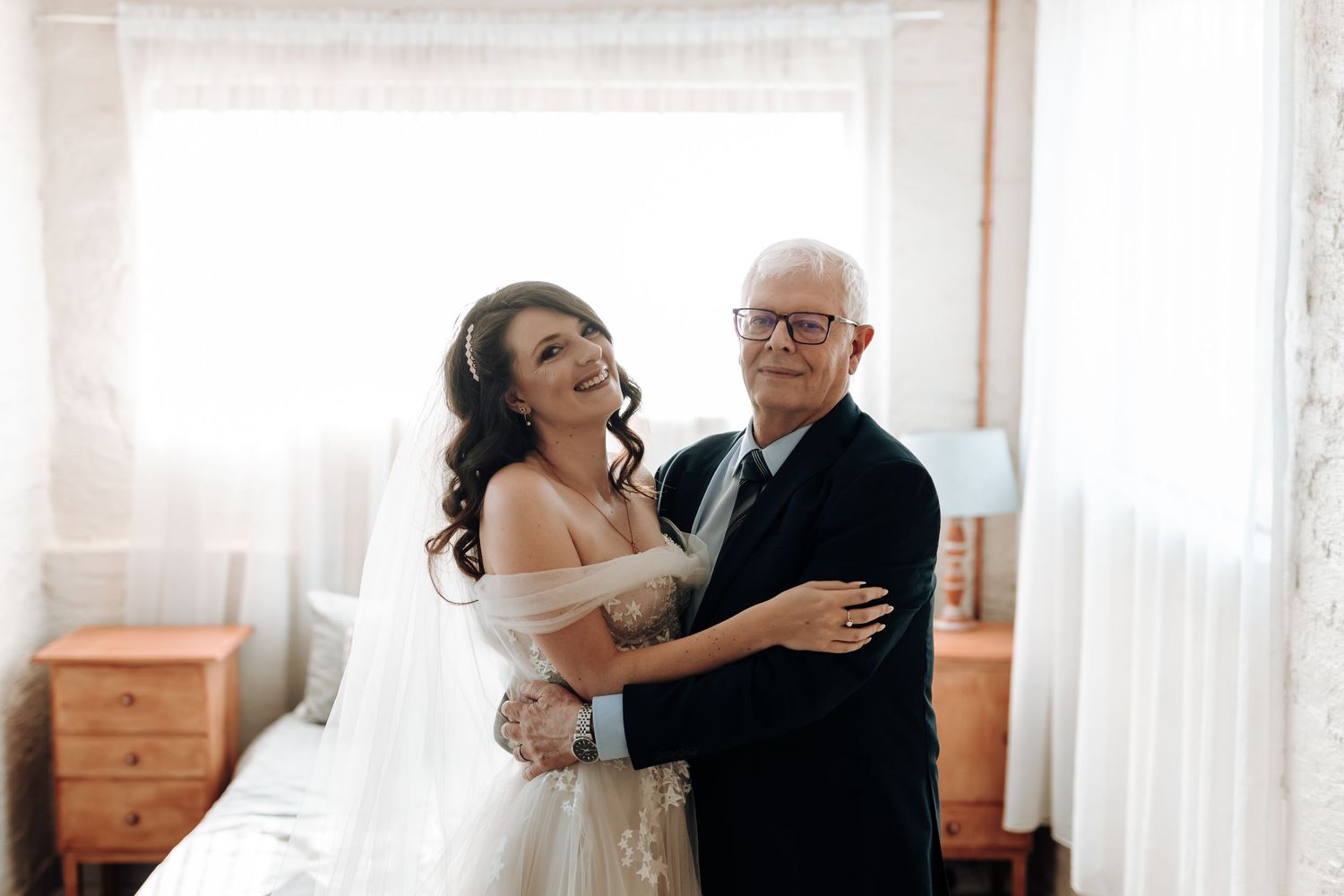 A joyful moment shared between a bride and someone during a wedding celebration.