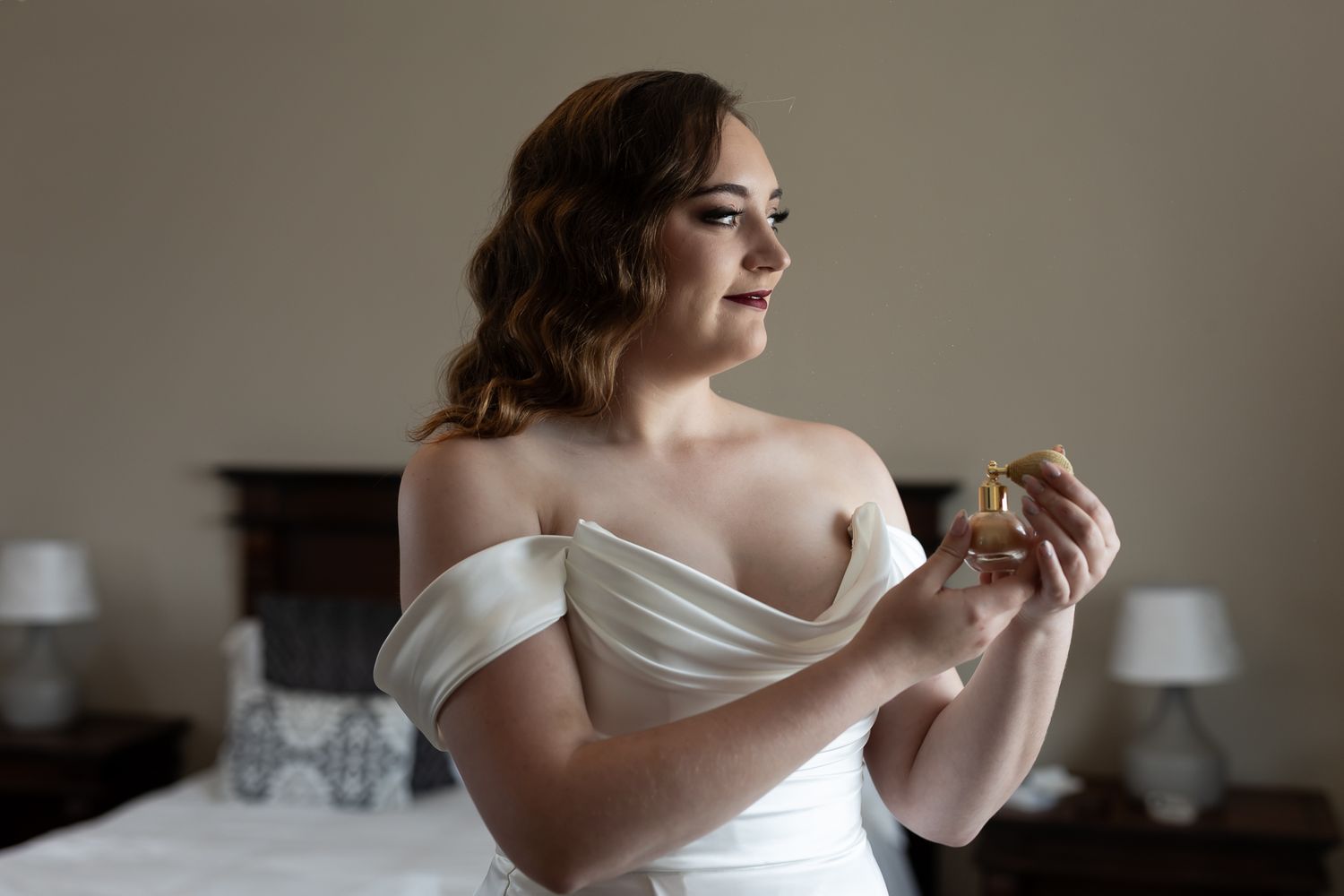 Wedding preparation scene with soft natural lighting and elegant white gown.