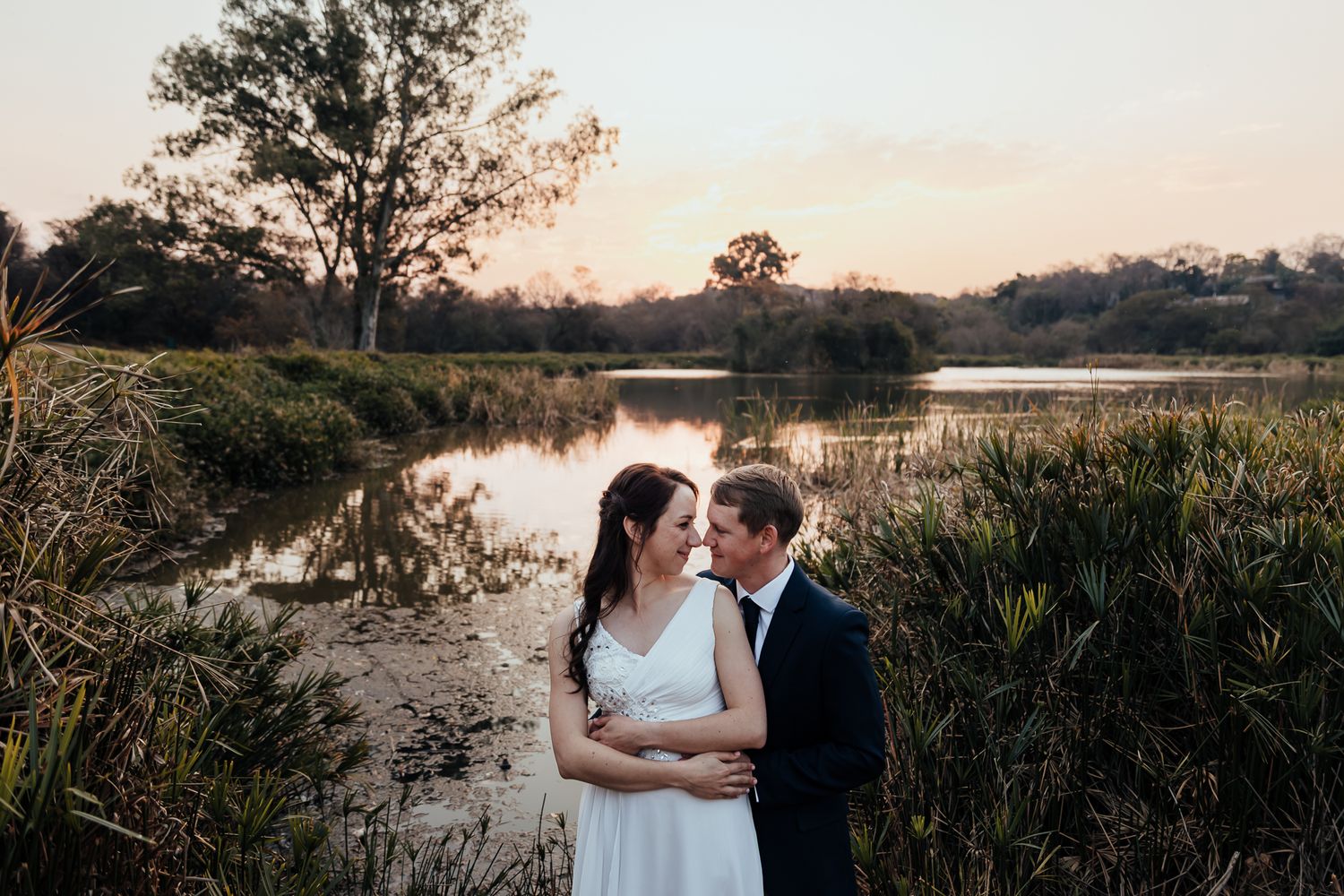 Romantic sunset photography session by a peaceful lakeside with natural golden light.