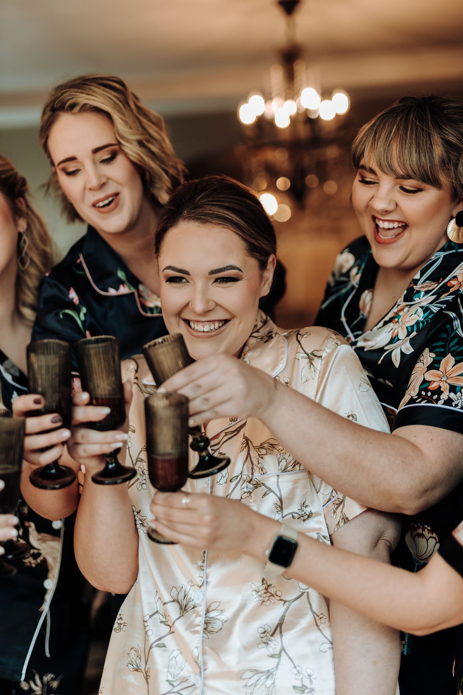 A celebratory moment with drinks and matching floral robes.