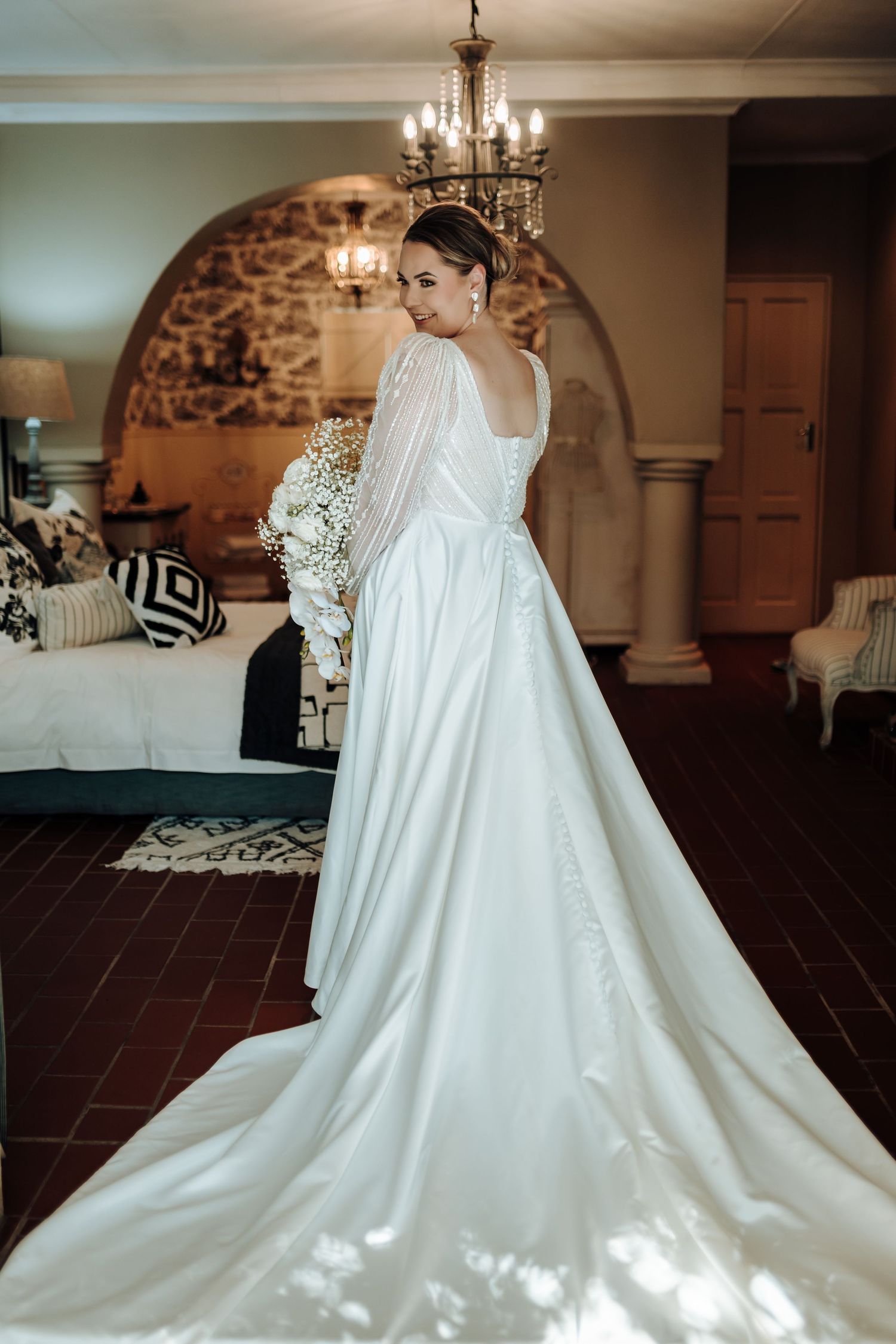 Full length view of wedding dress with dramatic train in classic bridal suite.