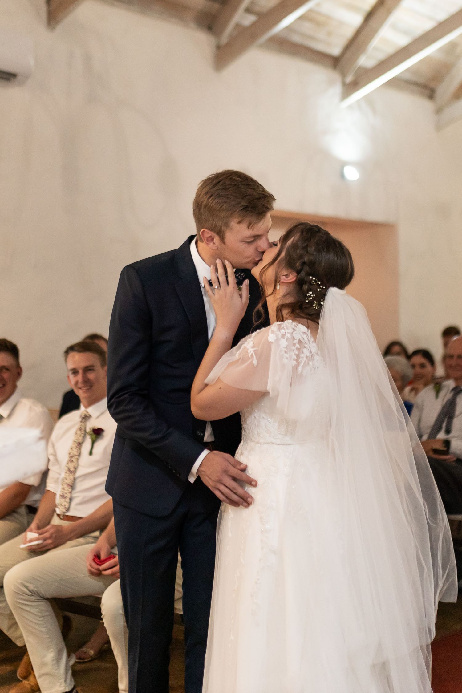 A tender moment captured between newlyweds during their indoor wedding ceremony.