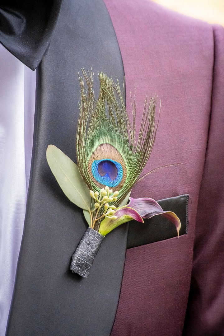 Groom's peacock feather and floral boutonniere