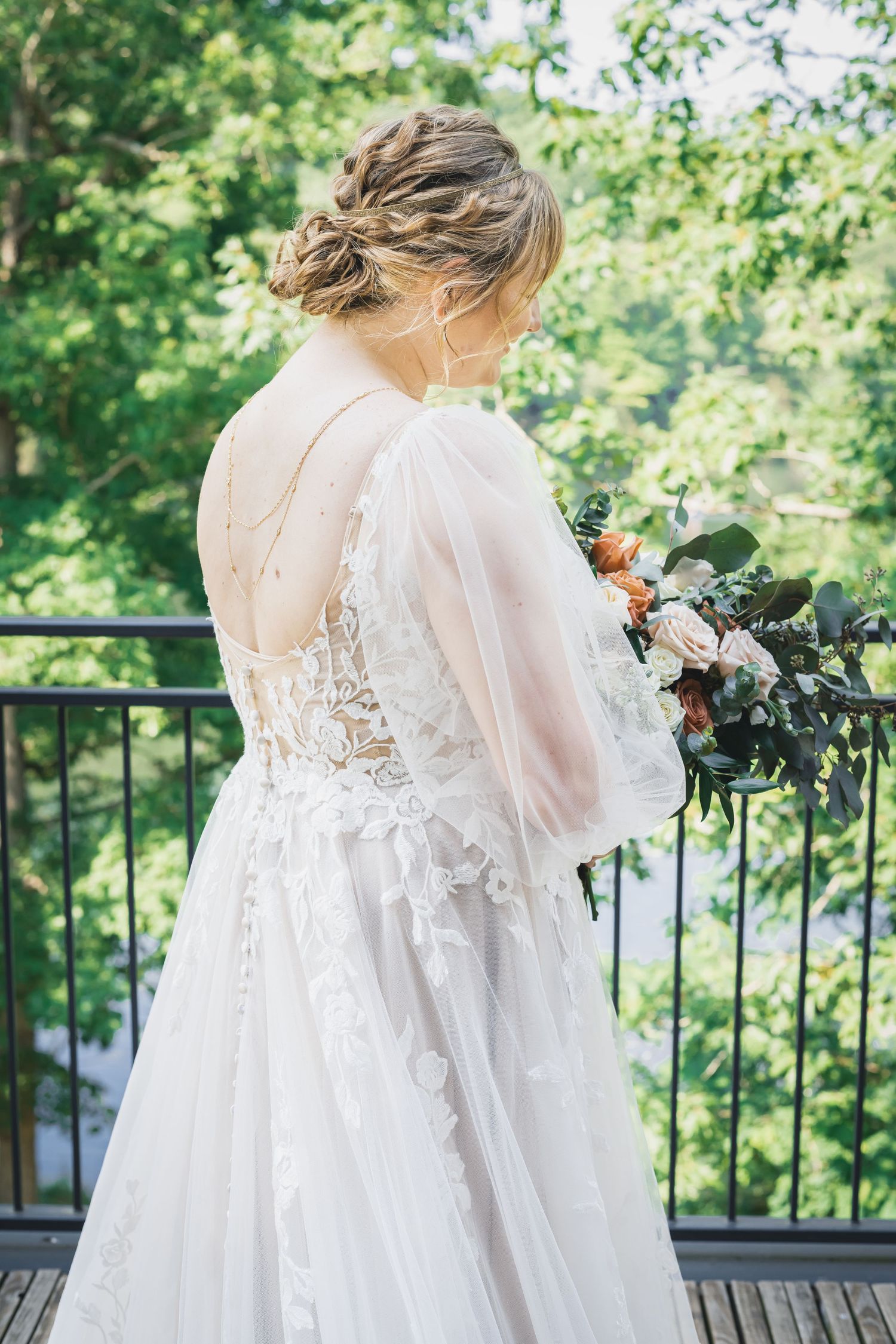 Bridal Portrait of the back of the gown, jewelry, reflecting upon her bouquet and the moments of her day.