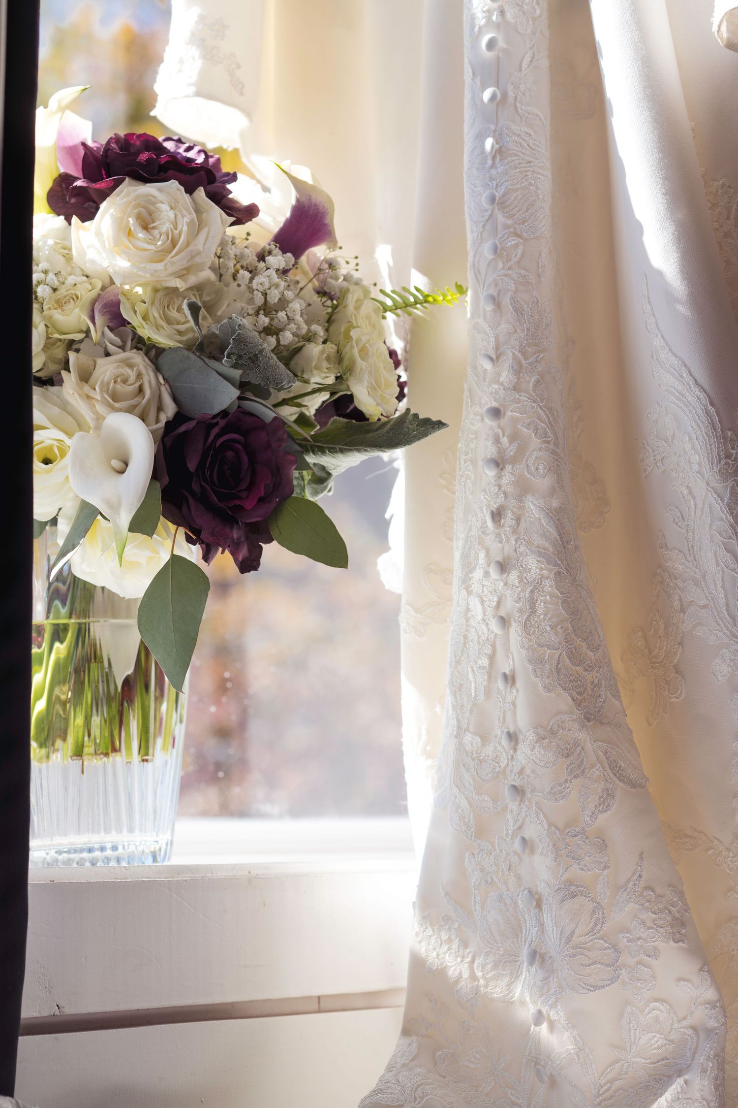 Detail photo of bride's wedding gown, dress, and bouquet pre-ceremony.