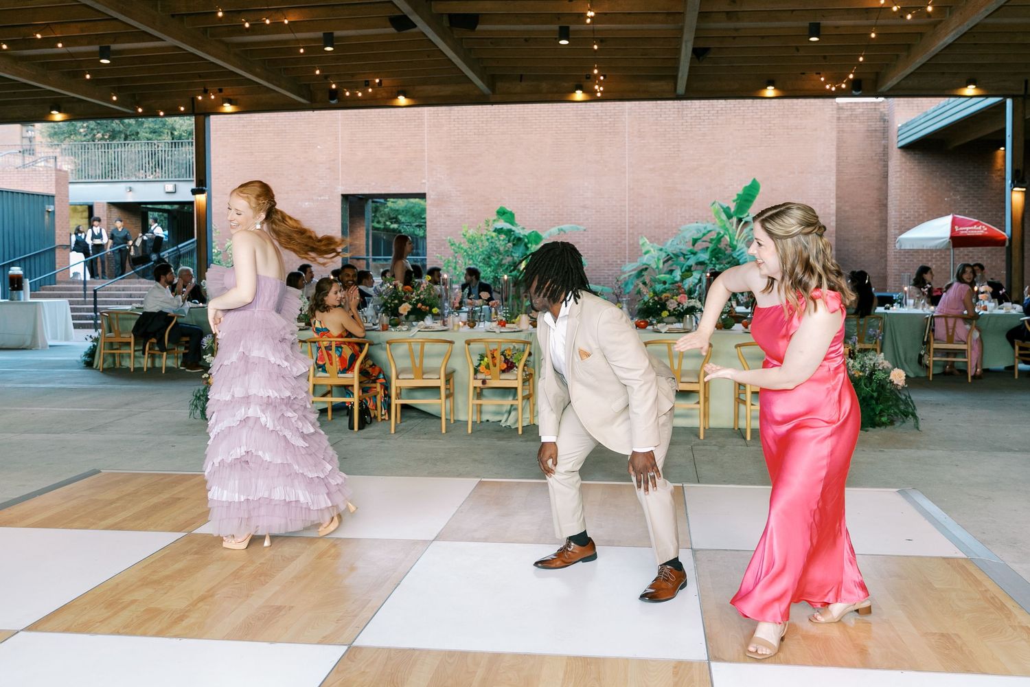 Wedding guests dancing and having fun on a modern dance floor at an elegant reception.