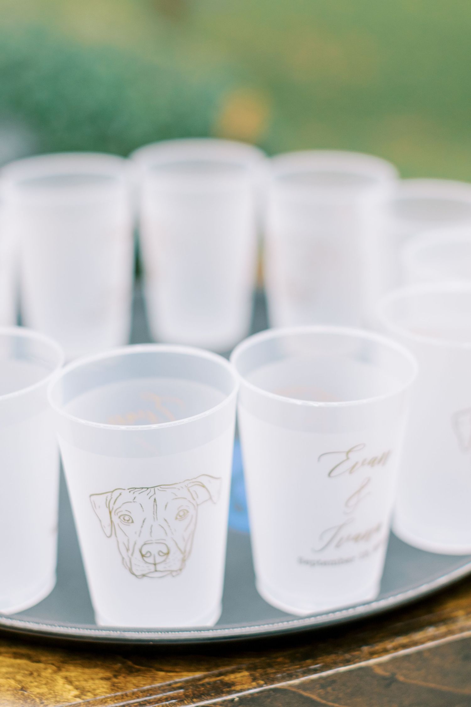 White crystal singing bowls arranged in a row with engraved designs for a wedding ceremony.