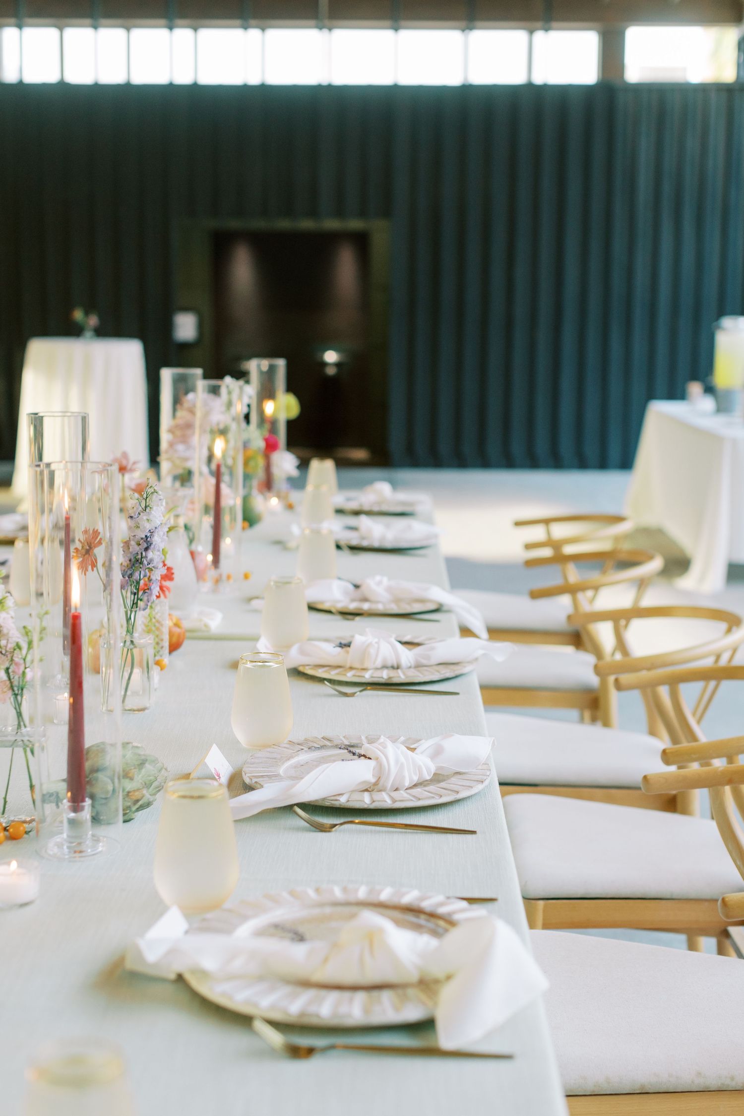 Elegant wedding reception tables set with white linens and delicate floral centerpieces.