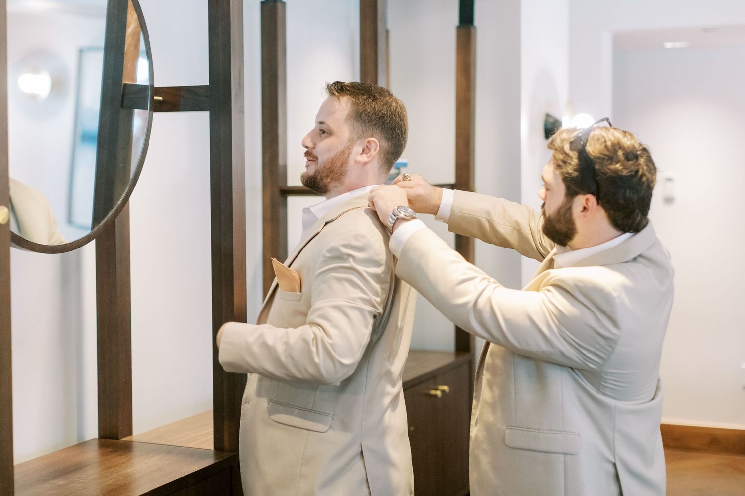 A figure in a light-colored suit reaches up to adjust a door hinge or hardware in this multi-panel sequence.