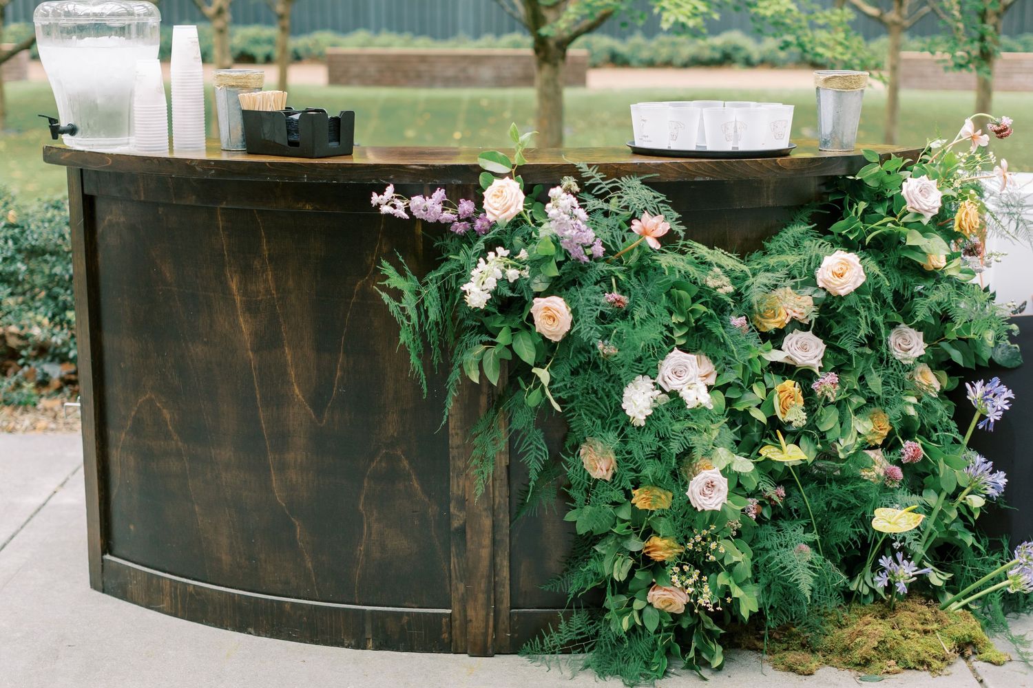 Rustic wooden wedding decor adorned with lush floral arrangements in soft pastel colors.