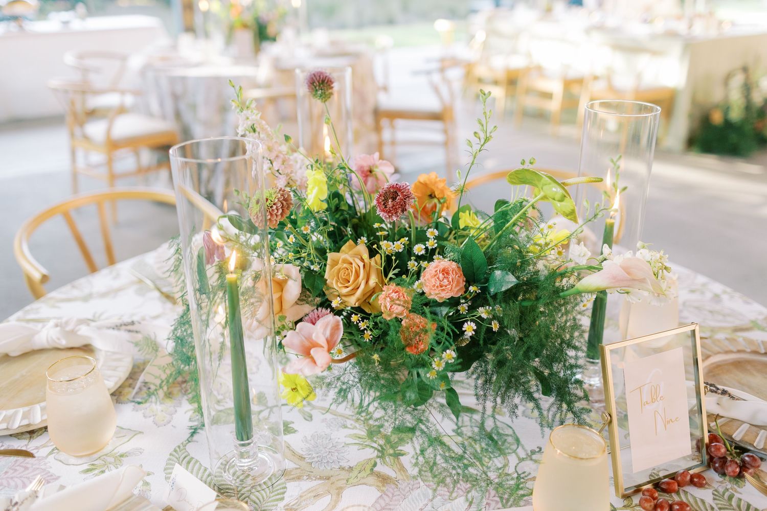 Romantic wedding table settings with delicate floral centerpieces and natural greenery.