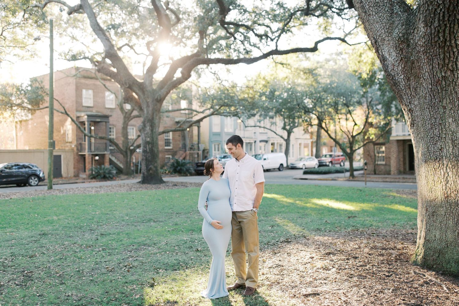 A collection of outdoor photos showing people walking and gathering around oak trees in a grassy lawn area near buildings.