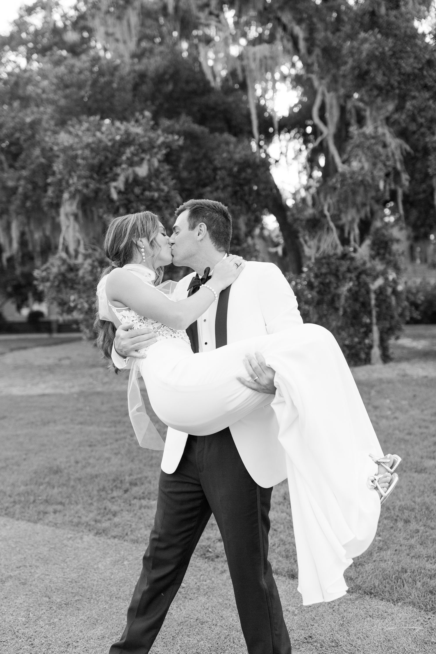 Romantic black and white portrait under Spanish moss trees.