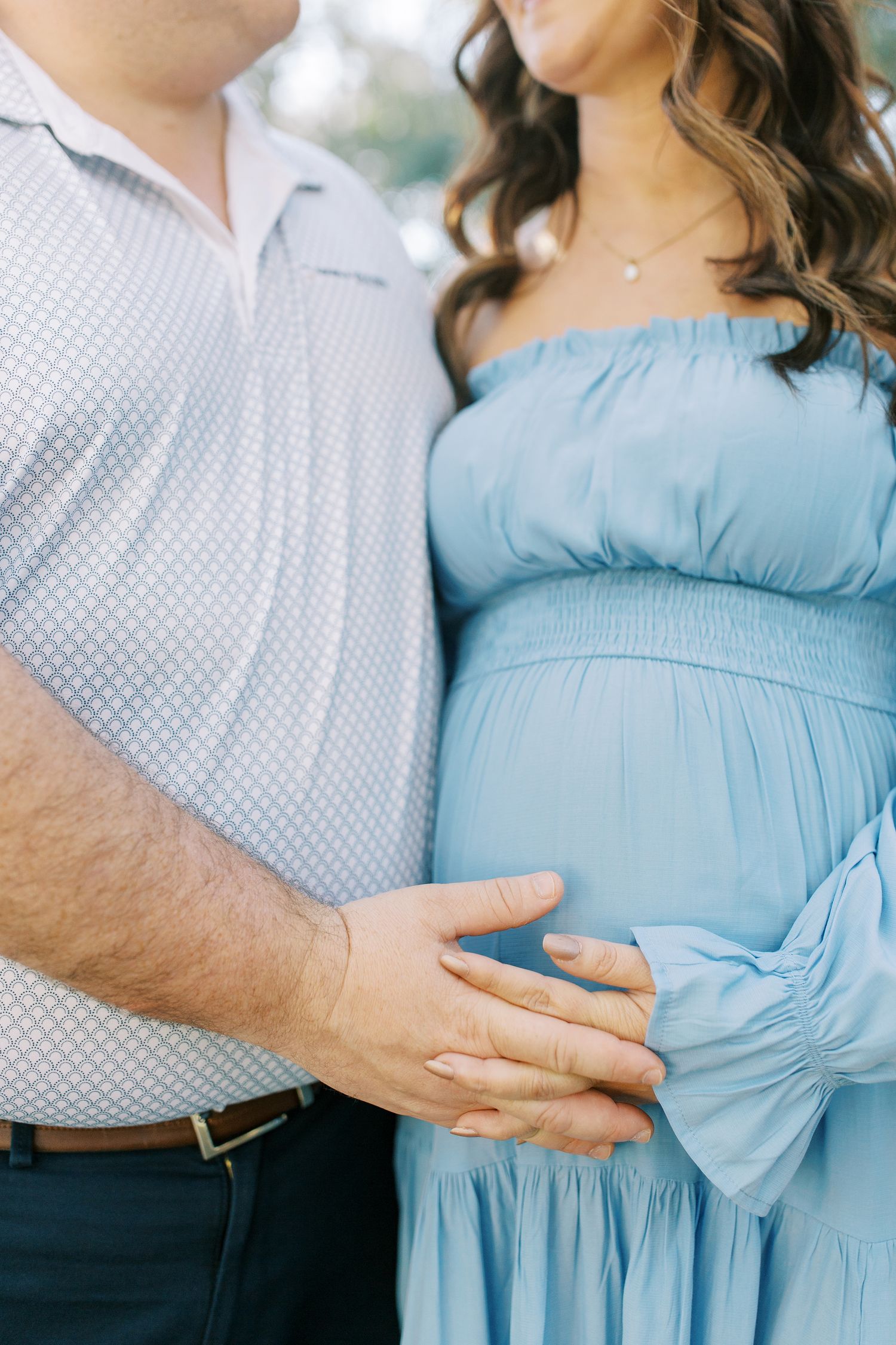 Close-up shots of a couple in blue dress and white shirt sharing tender moments outdoors.