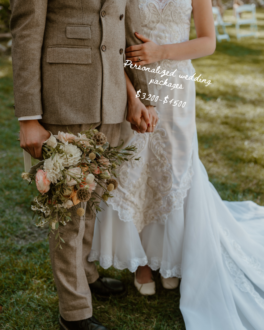 Wedding fashion detail showing brown suit and white lace dress with floral bouquet on grass.