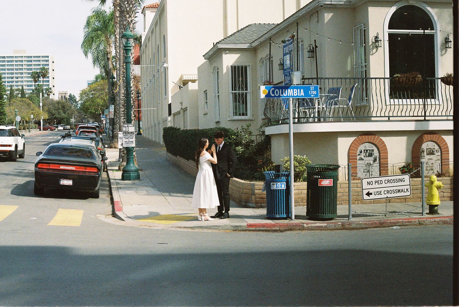 Panoramic view of a quiet suburban street with classic architecture and sidewalks.