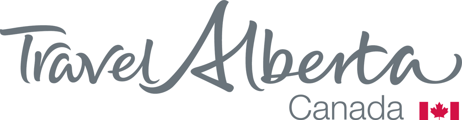 Travel Alberta tourism logo in gray text on transparent background.