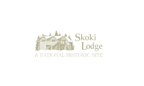 Vintage style Skoki Lodge historic site logo in monochrome beige.