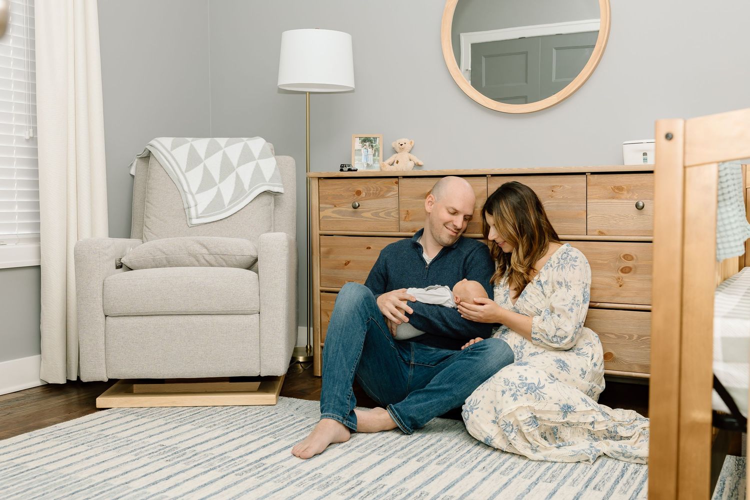 Intimate lifestyle photo in a neutral-toned nursery with wooden furniture.