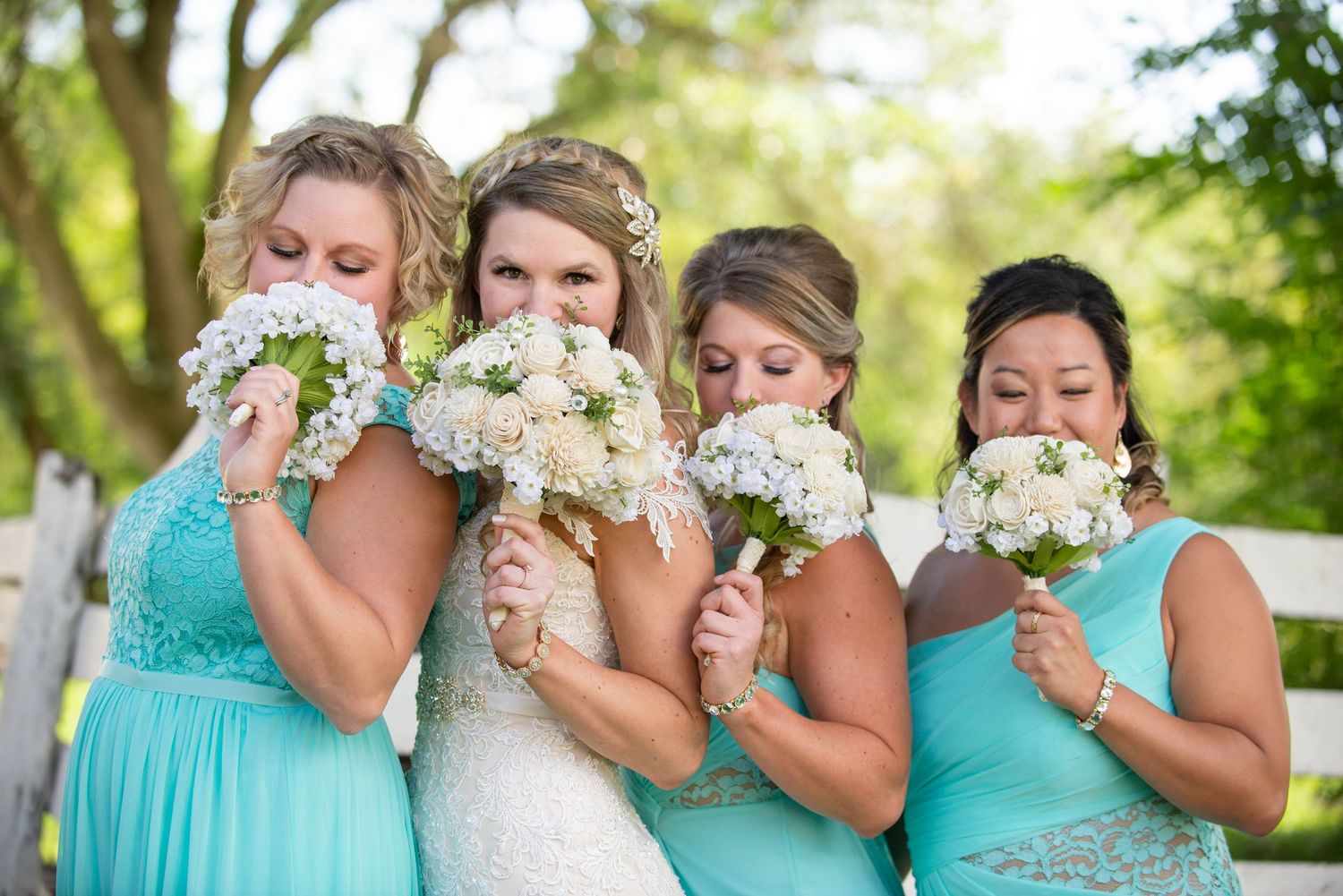 Bridesmaids in turquoise dresses share emotional moments with the bride. Rum River Barn Milaca Minnesota Weddings