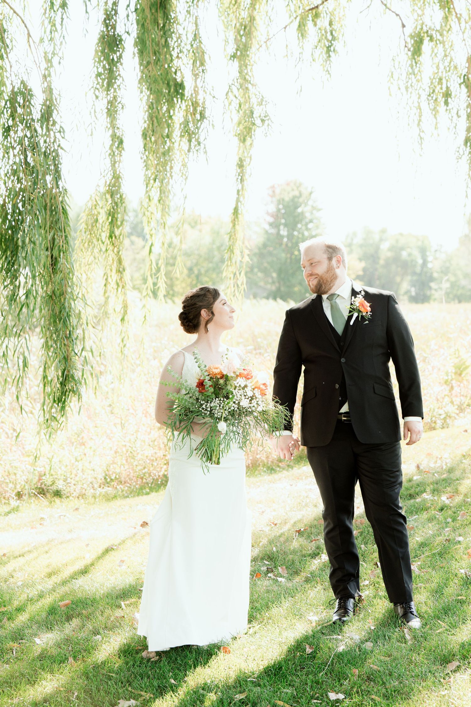 The Grands At Mulligans. Artistic series of wedding photos under weeping willow trees with dreamy sunlit backdrop.