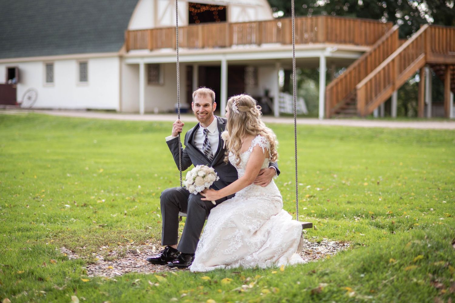 Wedding celebration on a grassy lawn with vintage decor and natural outdoor setting.