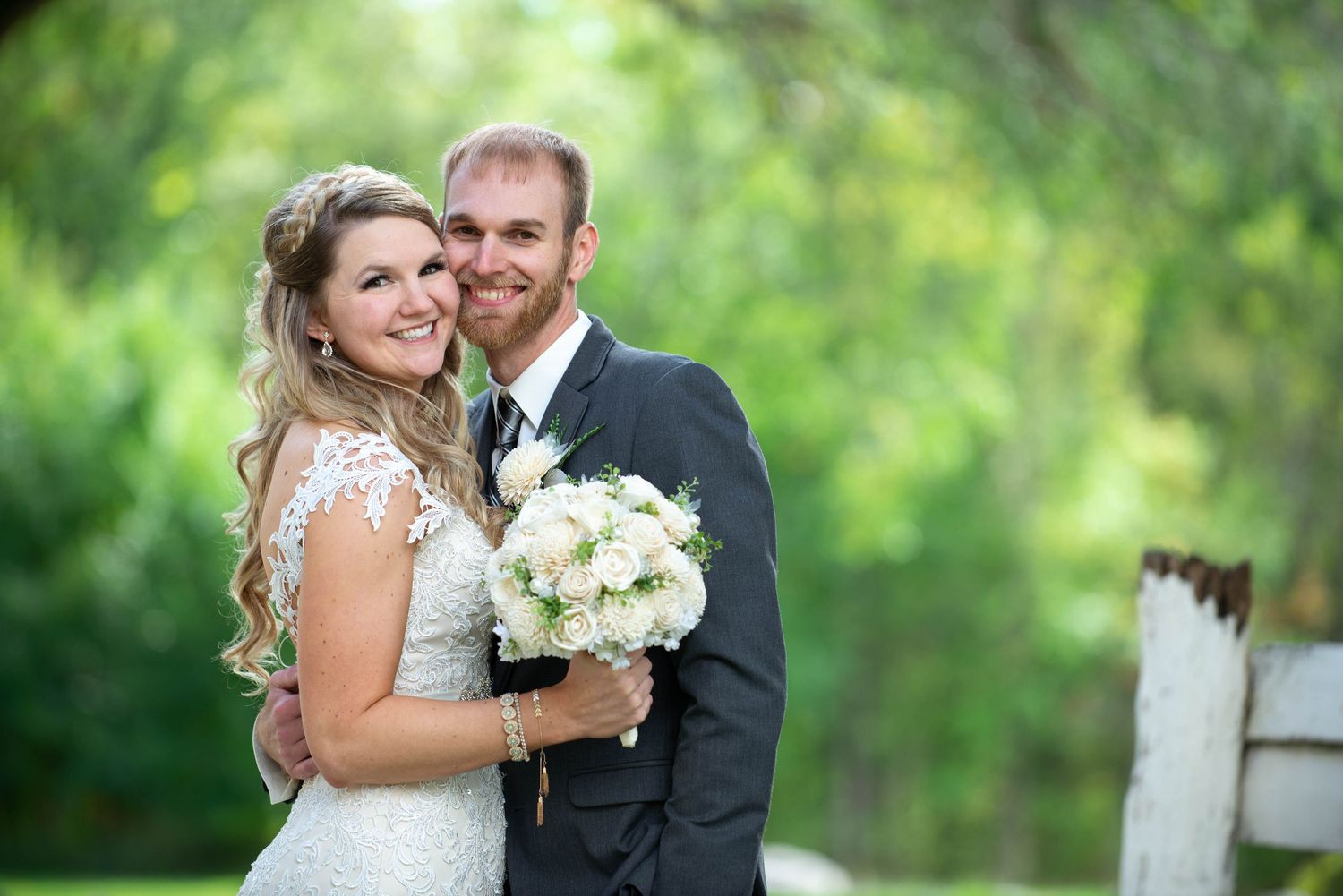 Elegant outdoor wedding portraits with white bouquet against lush green background. Rum River Barn Milaca Minnesota Weddings