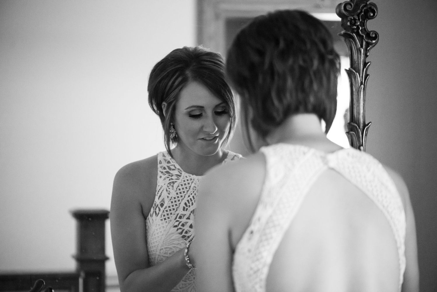 Black and white photos show final moments of bridal preparation with elegant dress details.
