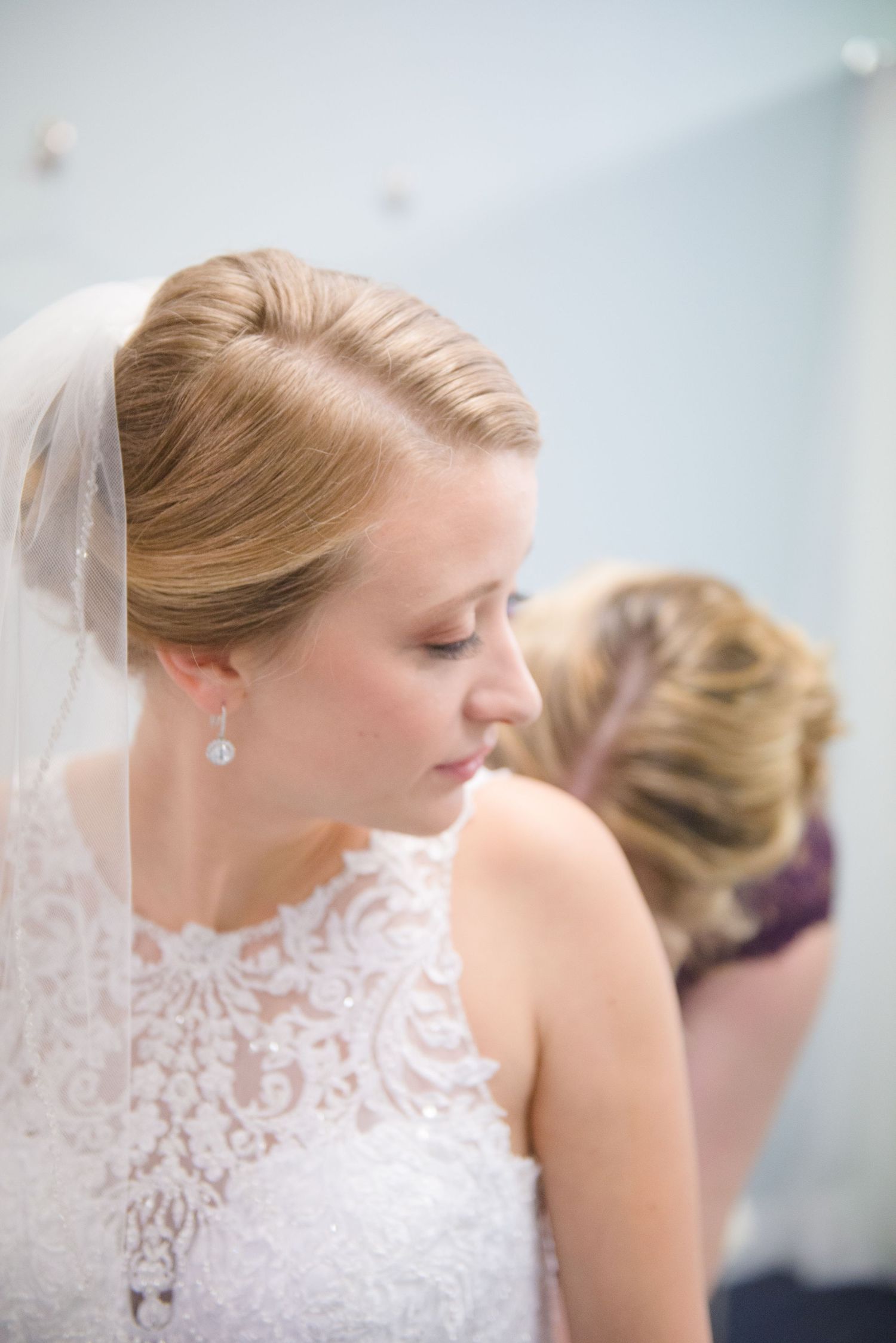 Profile views showing delicate lace details of a bride's wedding dress during preparation. Andover wedding at Magestic Oaks Golf Club